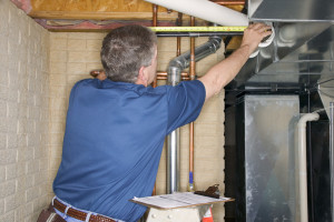 Handyman inspecting pipes